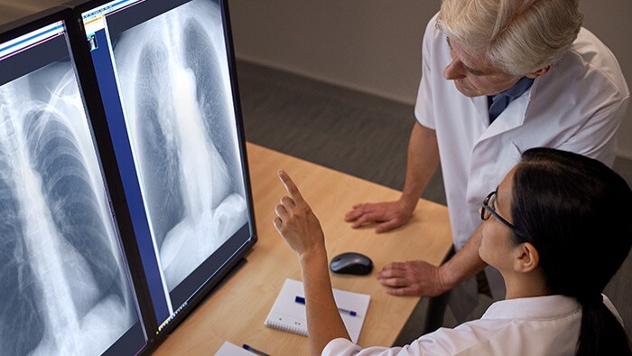 Two doctors working in front of monitors